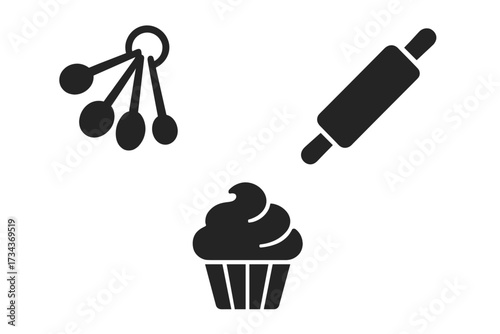 Collection of essential kitchen baking tools including measuring spoons, a rolling pin, and a delicious cupcake dessert
