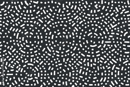 A modern abstract pattern featuring white geometric shapes on a dark background..