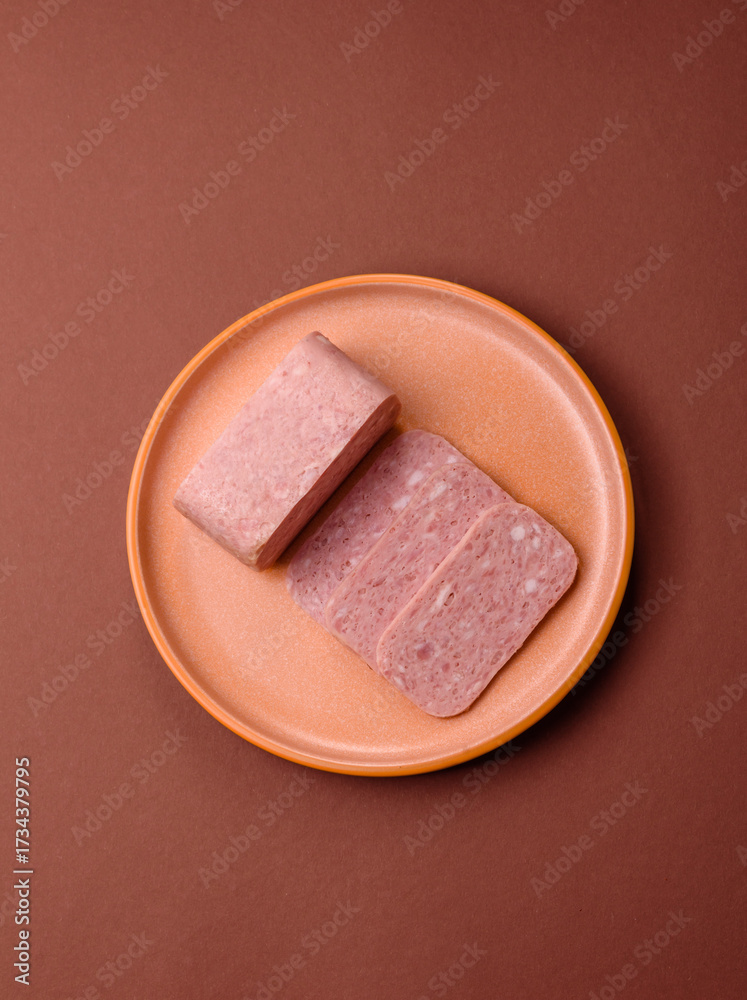 Fototapeta premium Spiced ham slices, canned meat for lunch sandwiches. Spiced ham as a food background