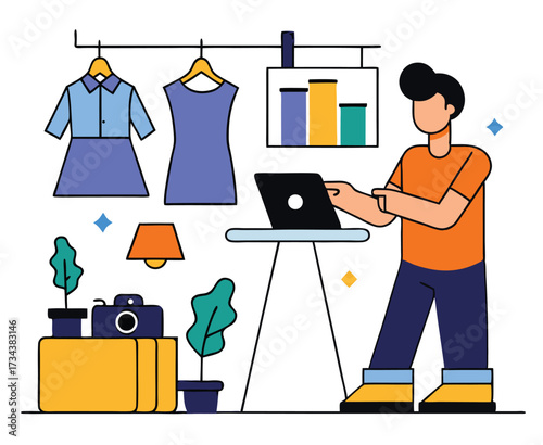 Man stands near a table using a laptop, in front of clothing items