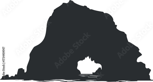 Silhouette of a rock formation with a cave opening and ocean waves in the foreground.