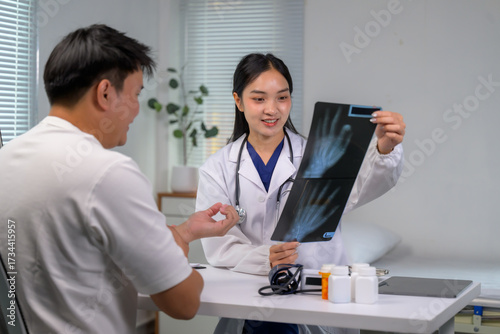 Doctor discussing x-ray results with patient at clinic