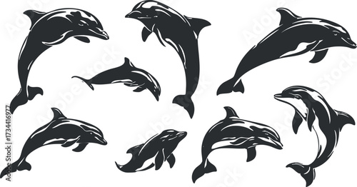 A collection of black silhouette dolphins gracefully jumping and swimming in the ocean..