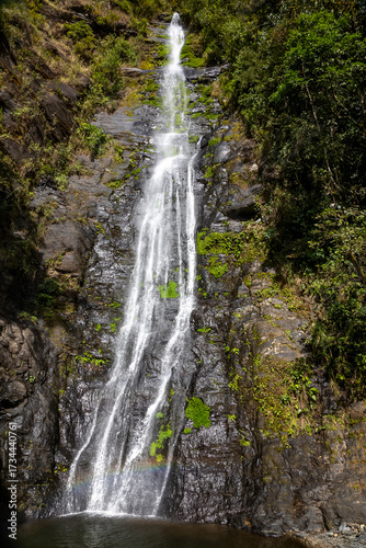 A beautiful mountain waterfall. The water falls into a lake. The waterfall is in Bolivia.