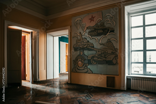  A beautiful hall in a huge abandoned palace. The interiors of an abandoned 18th-century palace. Beautiful architecture. Light from the windows falls into the em