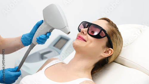 Quadro su tela Laser hair removal procedure in an aesthetic clinic, focusing on facial hair removal from a female patient