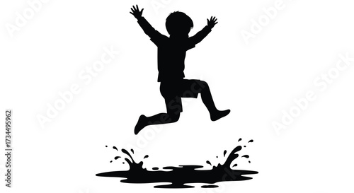 Joyful child jumping in a puddle a striking black silhouette