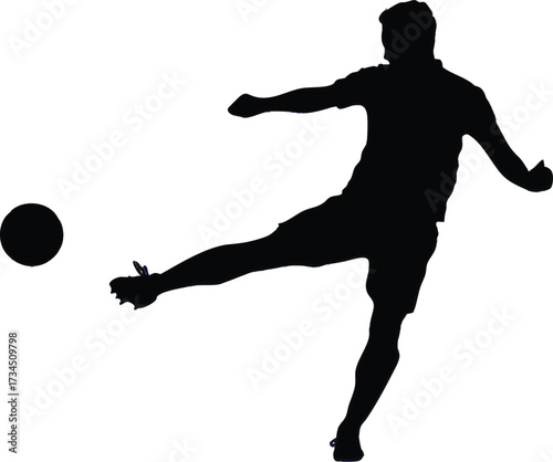 Silhouette of a soccer player kicking a ball football