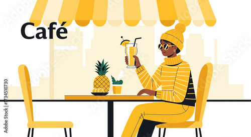 Stylish woman enjoying a tropical beverage at a cozy outdoor cafe setting with a vibrant yellow