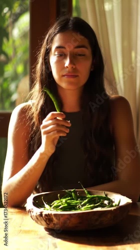 Woman Preparing Green Chili Peppers. Rustic Cooking with Fresh Peppers. Natural Light Food Preparation Scene.