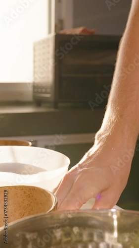 Vertical video. Essential Oil Being Poured Into Melted Wax in Silver Pot With Spatula Slow Motion, Homemade Candle Craft Hobby Concept