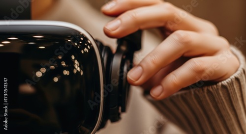 Close-up of female hand adjusting vr headset focus