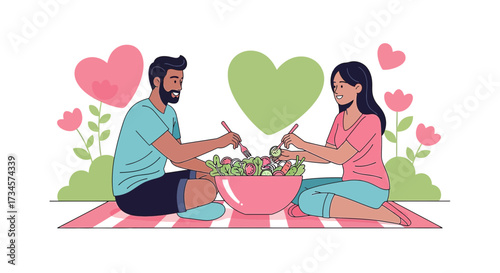 Lovely couple enjoying healthy picnic with fresh salad and heart decorations around them making a