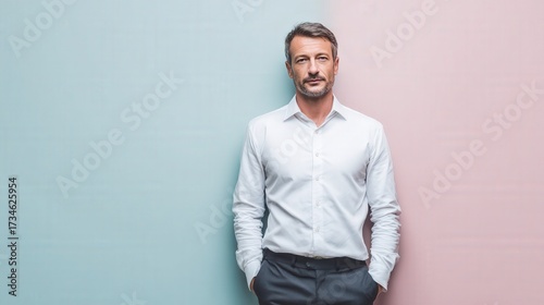 Confident Middle-Aged Man in a Stylish White Shirt Against a Colorful Background