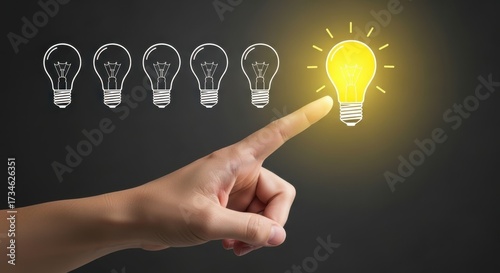 Finger points to brightest idea among multiple lightbulb concepts on dark surface