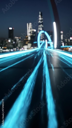 Smooth high-angle video over sleek futuristic digital highway, bright blue/cyan energy lines, blurred smart city skyline. Concept of high-tech digital transformation