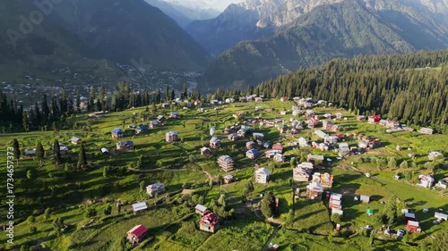 Aerial View of Arang Kel, Azad Kashmir — Scenic Mountain Village Surrounded by Lush Green Terraces, Dense Pine Forests, and Majestic Peaks under Clear Evening Light