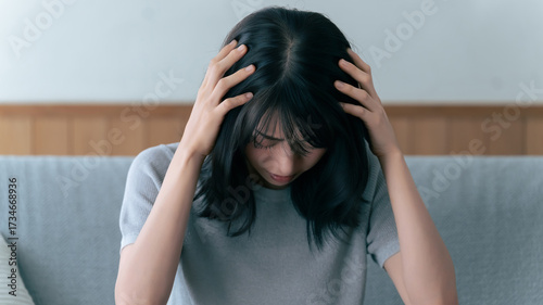 Foto 頭を抱える女性