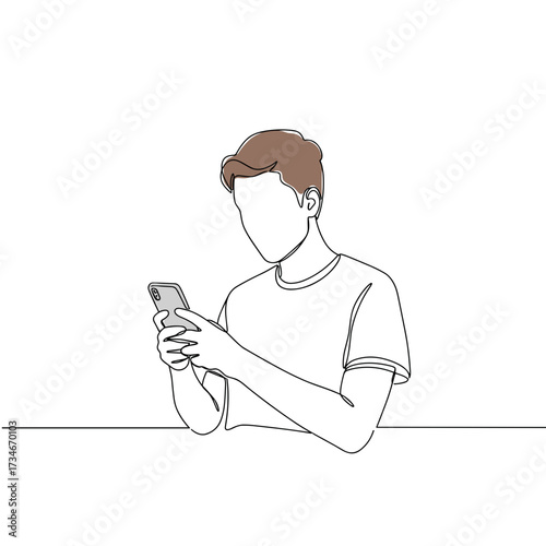 Young man using smartphone while sitting at table in minimalist style  