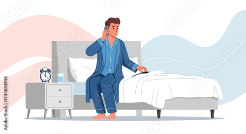 Man in pajamas sitting on the bed having a morning phone call in bedroom interior