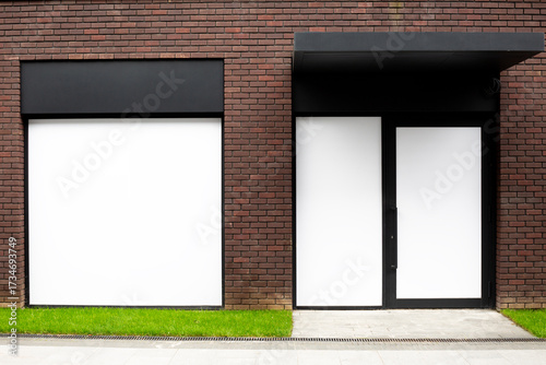Minimalist architecture of modern building facade featuring large empty panels, clean lines, and sleek black framed door. Urban design focusing on simplicity, symmetry and contemporary style