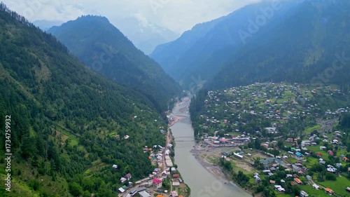 Aerial View of Scenic Mountain Valley Town with River Running Through Forested Hills — Peaceful Himalayan Settlement Surrounded by Nature