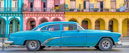 A blue American car is parked along a street