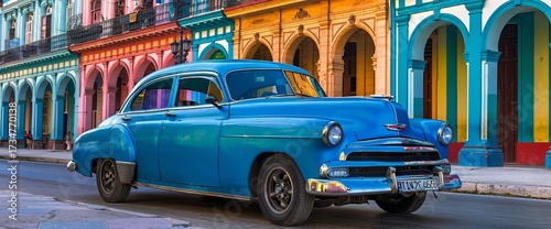 Classic blue American car parked on colorful street in the city