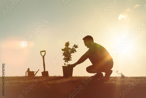 Φωτογραφία Man planting a tree in the garden