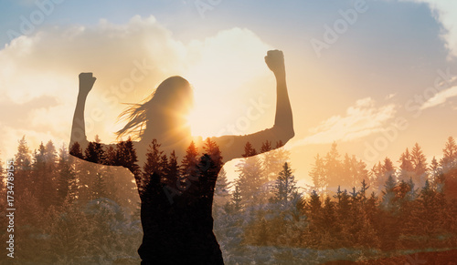 Young strong woman outdoors finding inner strength power vision winning mindset flexing facing the sun