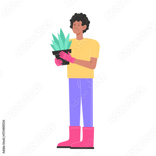 Person holding a potted plant wearing pink gloves and boots