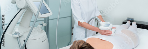 Bild auf Leinwand Woman in special white suit getting anti cellulite massage in a spa salon