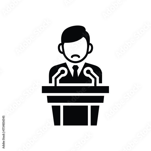 Man with a mustache delivering a speech at a podium during a formal event or conference