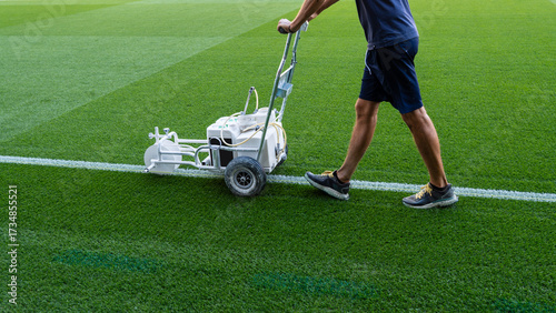 Machine for marking lines on the playing field, pushed by a man
