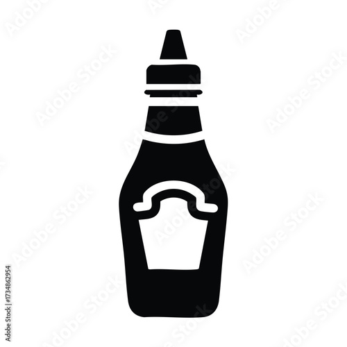 Close-up of a classic glass bottle with a pointed cap and a blank label, used for condiments or sauces in kitchens and dining settings