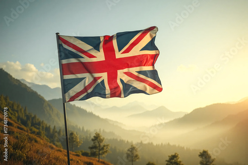 Flag of Great Britain flies from a flagpole. The Union Jack in the wooded highlands at evening.