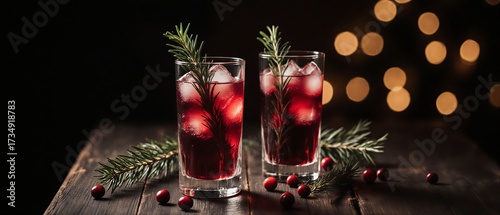 festive cranberry cocktail with pine branch and ice cubes on wooden surface | christmas, holiday, party, celebration, refreshment theme