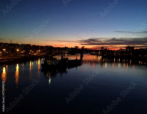 City skyline at dusk over a river