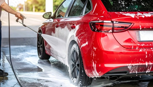 Red car being washed at a self-service car wash