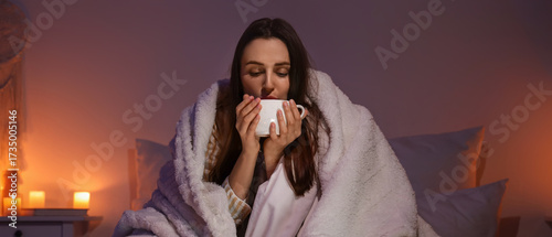 Young woman with blanket dr...