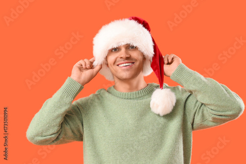 Happy young man in Santa ha...
