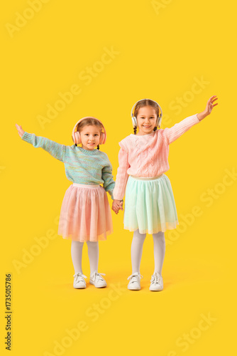 Cute little girls in headph...