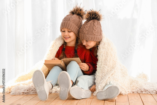 Cute little girls in warm h...