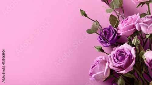 Elegant purple and pink roses with leaves on soft background to promote a romantic event and special day