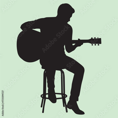 Silhouette of a young man sitting on a chair and playing an acoustic guitar on a white background