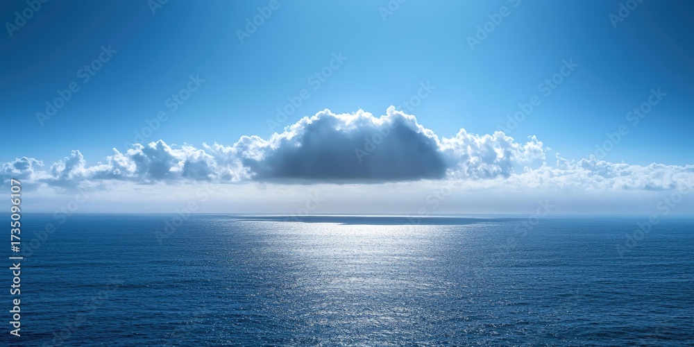 Obraz premium A vast, open ocean with a single, large, white cloud floating above it, casting a soft, diffused light on the water below.