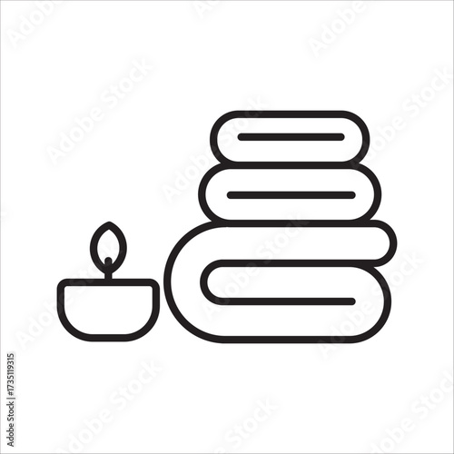 Minimalist spa and relaxation symbol with neatly folded towels and a glowing candle for wellness and comfort