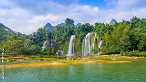 Lush green waterfall cascading into a wide turquoise river