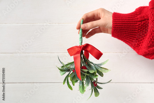 Female hand with mistletoe ...