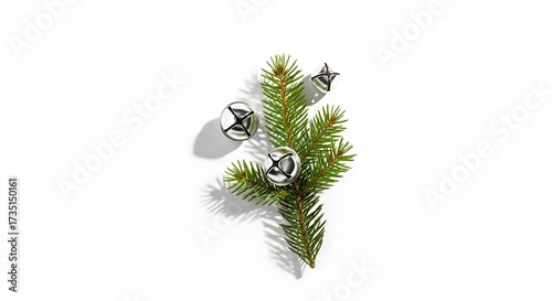 Minimalist christmas decoration with a fir branch and three silver jingle bells isolated on white background, creating a simple and elegant holiday theme